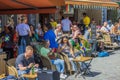 View of people in outdoor cafÃ© decorated with Swedish flags in honor of National Day. Stockholm. Royalty Free Stock Photo