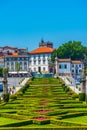 View of people passing over jardim do largo da Republica do Brasil square in Portuguese city Guimaraes