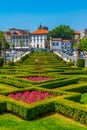 View of people passing over jardim do largo da Republica do Brasil square in Portuguese city Guimaraes