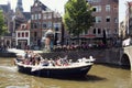 View of people riding a boat on canal doing a cruise tour