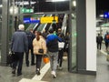 View of people taking the escalator - emergency exit arrows in the central station of Frankfurt