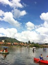 VIEW OF PEOPLE TOURING ON THE LAKE WITH BEAUTIFUL BLUE CLOUDS