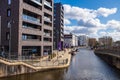 View of people walking and boats moored in a canal in New Islington, a newly developed area in Manchester Royalty Free Stock Photo