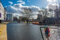 View of people walking and boats moored in a canal in New Islington, a newly developed area in Manchester Royalty Free Stock Photo