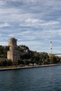 View of people walking by Bosphorus, historical fortress called Rumeli Hisari and FSM bridge in Istanbul. Royalty Free Stock Photo