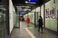 View of people walking through a corridor toward the escalators of the subway station in Frankfurt