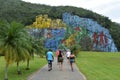 View of people walking towards the Mural de la Prehistoria