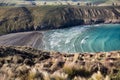 View on periodic waves in rocky Tumbledown bay with black sand beach on Banks Peninsula Royalty Free Stock Photo