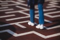 View of a person feet legs trapped and trying to find escape and exit from maze labyrinth, concept of finding solution to problem Royalty Free Stock Photo