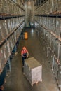 View of a person in a storage compartment with lots of containers on the shelves