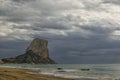 View of PeÃÂ±on de Ifach on a stormy and cloudy day from Playa del Arenal.