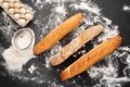 view photo of a variety of french baguette on a black board background eggs sieve and flour. Still life captured from