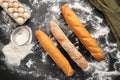 view photo of a variety of french baguette on a black board background eggs sieve and flour. Still life captured from