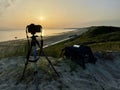 View of the photographer's equipment on the beach at sunset Royalty Free Stock Photo