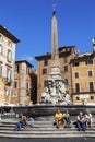 A view of the Piazza Rotunda with a fountain and obelisk of Ramses II and numerous tourists, Rome