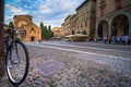 View of the piazza Santo Stefano at the evening with people and a bicycle, Bologna, Italy.