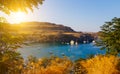 View of picturesque Bay of Lindos with boats and yachts, the famous lagoon among the rocks, sunset, sunlight, Rhodes Greece Royalty Free Stock Photo