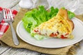 Piece of vegetable quiche with salad on a plate