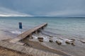View of a pier in Izola below Bellevedere viewpoint on the north of Adriatic coast. Cloudy weather and long pier Royalty Free Stock Photo