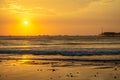 A view of the pier and the Pacific Ocean. Sunset over sea waves Royalty Free Stock Photo