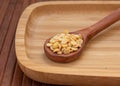 View of pigeon pea also known as toor dal in a wooden spoon. Isolated on wooden plate Royalty Free Stock Photo