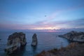 View of Pigeon Rock Raouche at sunset with an airplane flies over. Beirut, Lebanon Royalty Free Stock Photo