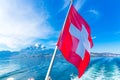 View of Pilatus Mountain and swiss flag from Lake Lucerne, Switzerland Royalty Free Stock Photo