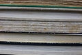 View on pile of antique yellowed books with edges of cover and textblock