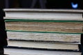 View on pile of antique yellowed books with edges of cover and textblock