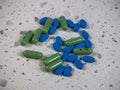 Seattle, WA USA - circa May 2022: View of a pile of colorful green and blue fluoxetine pills on a white countertop Royalty Free Stock Photo