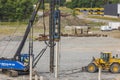 View of pile driving machine driving piles into ground construction site. Sweden