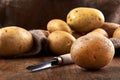 View of pile of new potatoes with jute bag on wooden table Royalty Free Stock Photo