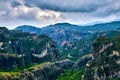 View on pillars of sedimentary rocks in famous Meteora valley at overcast day. Roussanou nunnery and Varlaam monastery Royalty Free Stock Photo