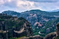 View on pillars of sedimentary rocks in famous Meteora valley at overcast day. Roussanou nunnery and Varlaam monastery Royalty Free Stock Photo
