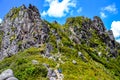 View from The Pinnacles Track Hike with blue sky above and person tourist in blue tshirt in the foreground at Coromandel