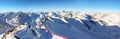 View from Pitztal glacier into the high alpine mountain landscape with cable car station and ski slope in winter with lots of snow