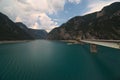 Piva lake going through a valley with an old rusty bridge connecting both shores Royalty Free Stock Photo