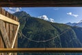The view of Piz Beverin in Switzerland from the window of an old log stable during summer Royalty Free Stock Photo