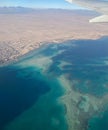 View from the plane. Airplane wing. Flight over the sea. Sea view from the plane. Royalty Free Stock Photo