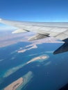 View from the plane. Airplane wing. Flight over the sea. Sea view from the plane. Royalty Free Stock Photo