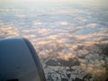 View from the plane with the engine, clouds and snowy lands Royalty Free Stock Photo