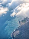 View from plane window. Aerial top view of sea, sky, clouds and ground Royalty Free Stock Photo
