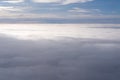 The view from the plane window of dense curly clouds and the blue stratosphere. Cloudscape. Blue sky and white cloud Royalty Free Stock Photo