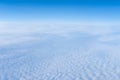 The view from the plane window of dense curly clouds and the blue stratosphere. Cloudscape. Blue sky and white cloud Royalty Free Stock Photo