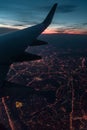 the view from the plane window of the night city, the wing of the plane and the night city