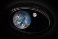 View on the planet Earth and moon among the stars in outer space from the spacecraft porthole. Royalty Free Stock Photo