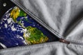 View of the planet the Earth and the Moon when we unfasten the gray metal zipper clasp Royalty Free Stock Photo