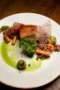 view on plate with dish of piece of baked pork meat with buckwheat and vegetables