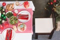 View of plates, salad, asparagus, wine glass, candles and gift on table in christmas