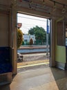 View of platform through open sliding doors from inside of an empty commuter train car Royalty Free Stock Photo